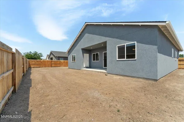 a view of an house with backyard and road