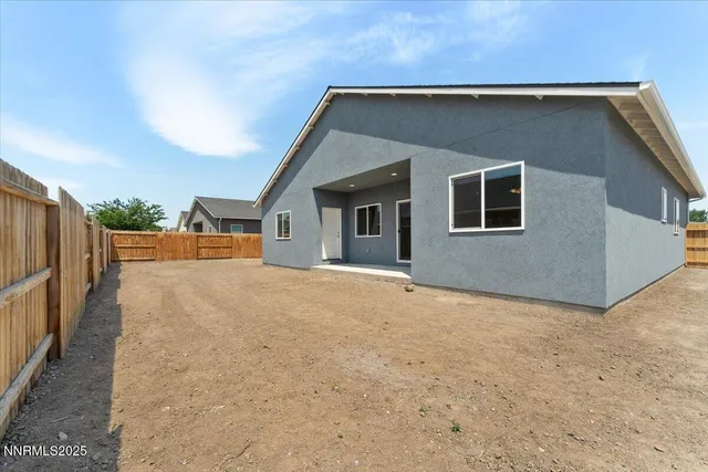 a view of an house with backyard and road