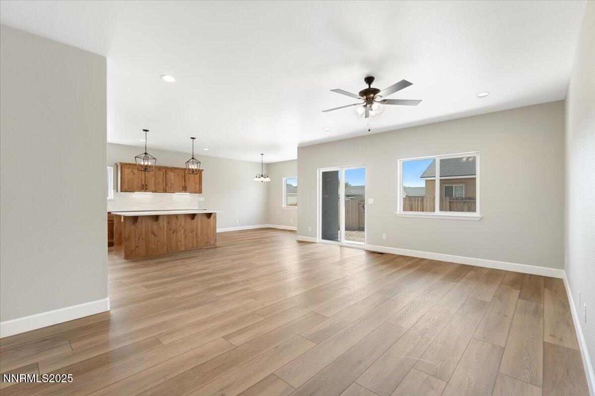 815 Great Basin Lane Fallon, NV 89406 - Photo 9 of 49 a view of an empty room with a window and wooden floor