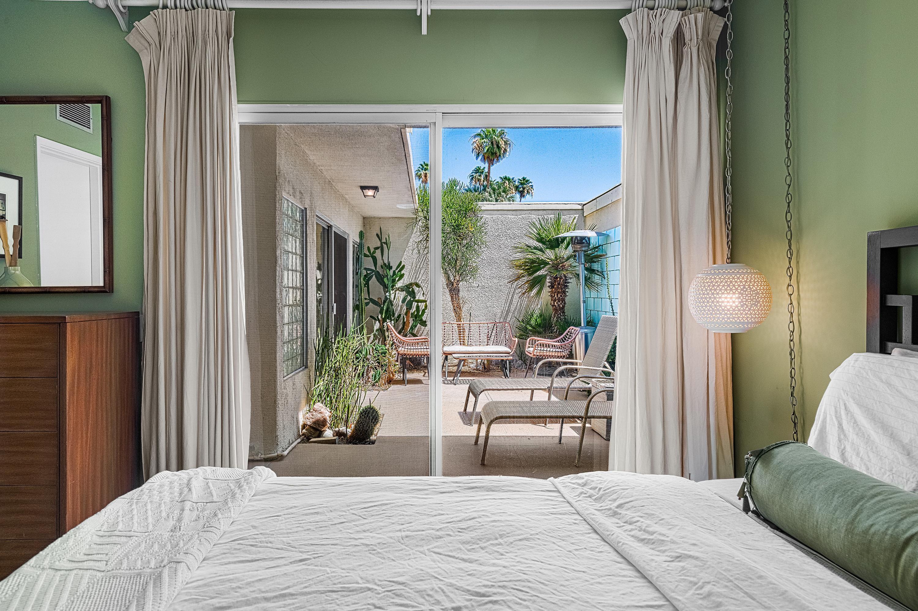 1855 Ramon Road, Unit 14 Palm Springs, CA 92264 - Photo 25 of 34 a bedroom with a bed and a potted plant