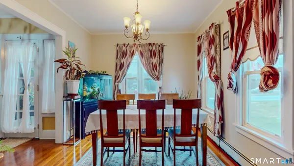 a view of a dining room with furniture and chandelier