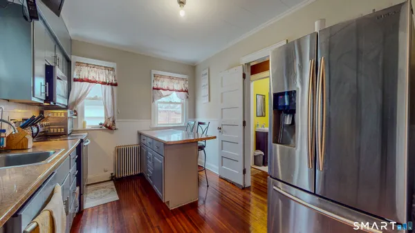 a kitchen with stainless steel appliances granite countertop a refrigerator and a stove