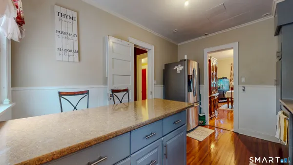 a kitchen with stainless steel appliances granite countertop a refrigerator and a sink