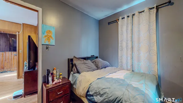 a bedroom with a bed and a window