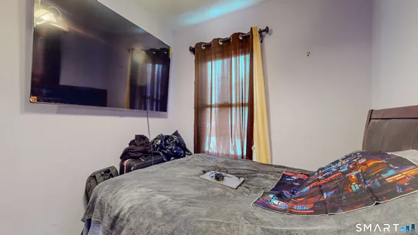 a bedroom with a bed and a window