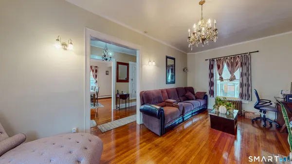a living room with furniture and a chandelier