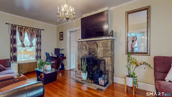 a living room with furniture a fireplace and a flat screen tv