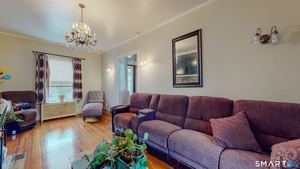 a living room with furniture and a chandelier