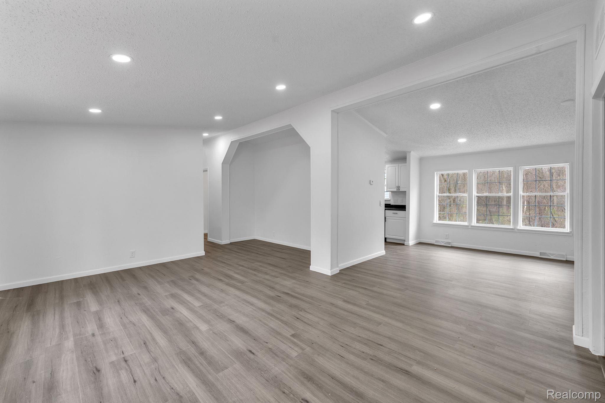 36085 Wick Road Romulus, MI 48174 - Photo 20 of 43 Unfurnished living room with a textured ceiling, light wood finished floors, and recessed lighting