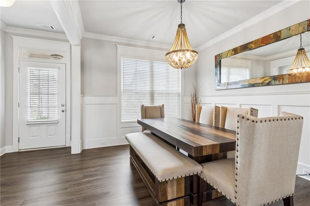 4417 Chestnut Oak Way Gainesville, GA 30504 - Photo 17 of 63 a view of a dining room with furniture wooden floor and chandelier