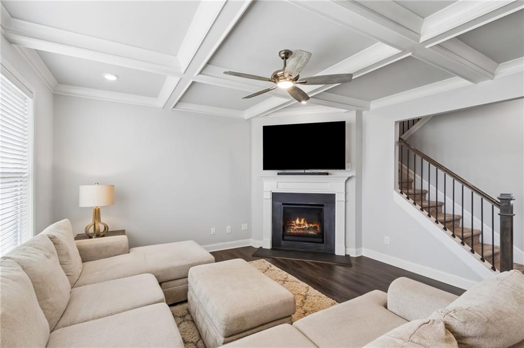 4417 Chestnut Oak Way Gainesville, GA 30504 - Photo 26 of 63 a living room with furniture a flat screen tv and a fireplace