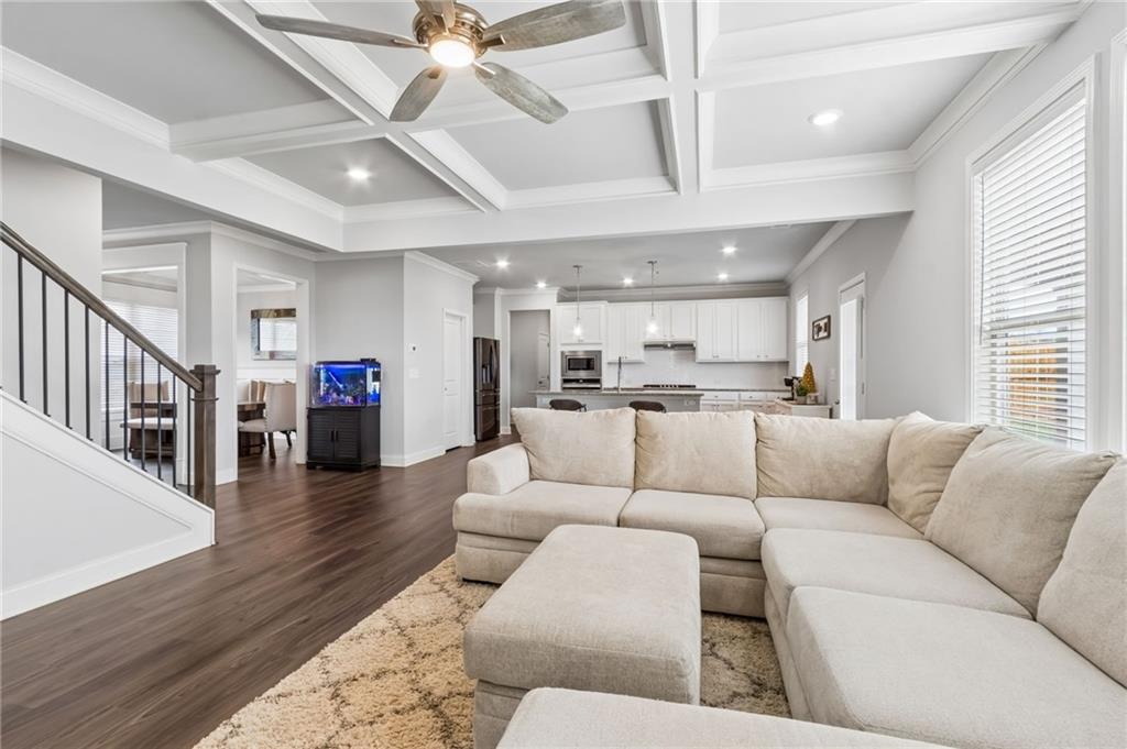 4417 Chestnut Oak Way Gainesville, GA 30504 - Photo 27 of 63 a living room with furniture kitchen view and a wooden floor