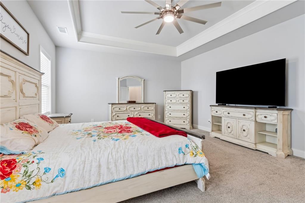 4417 Chestnut Oak Way Gainesville, GA 30504 - Photo 42 of 63 a bedroom with a bed and a flat screen tv