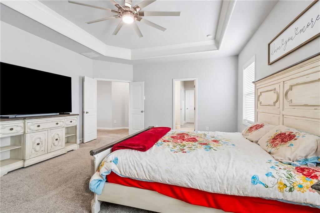 4417 Chestnut Oak Way Gainesville, GA 30504 - Photo 44 of 63 a bedroom with a bed and a flat screen tv in it