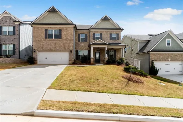 a front view of a house with a garden