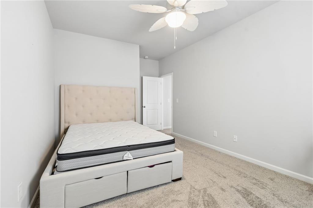 4417 Chestnut Oak Way Gainesville, GA 30504 - Photo 55 of 63 a room with a bed and a chandelier