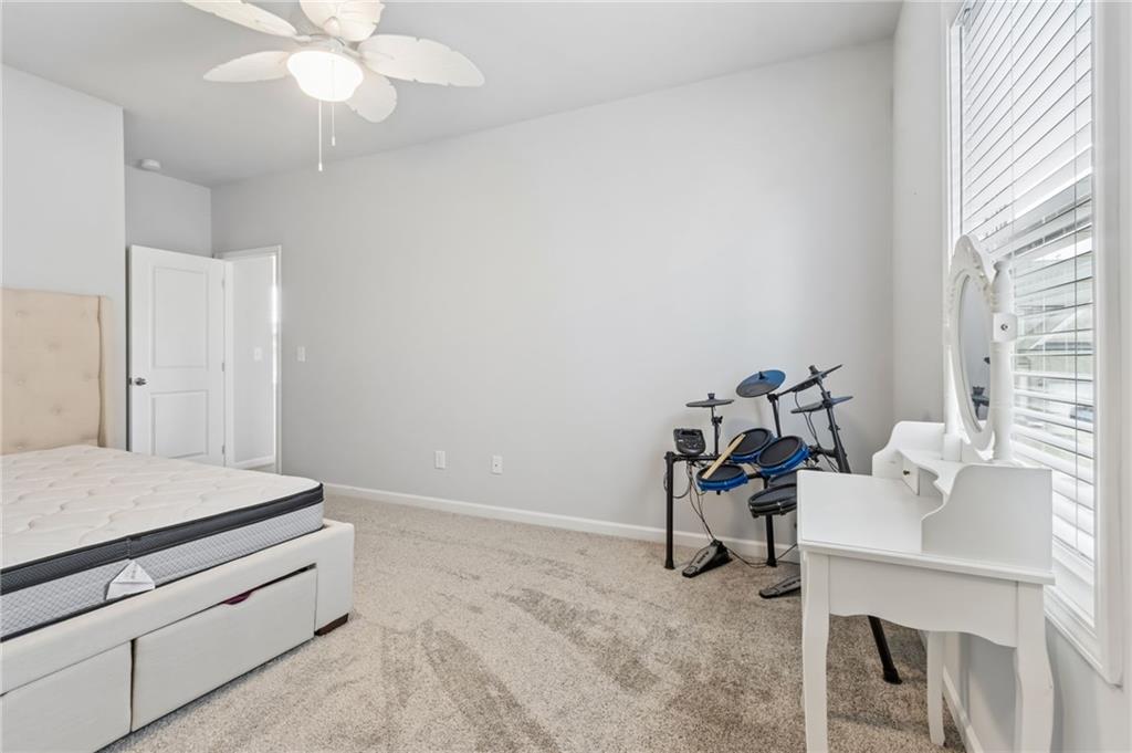 4417 Chestnut Oak Way Gainesville, GA 30504 - Photo 56 of 63 a bedroom with a bed and a chandelier