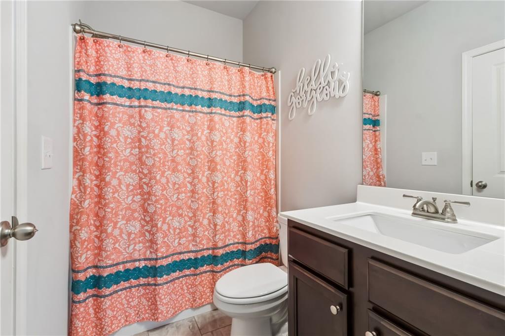 4417 Chestnut Oak Way Gainesville, GA 30504 - Photo 61 of 63 a bathroom with a sink a toilet and a mirror
