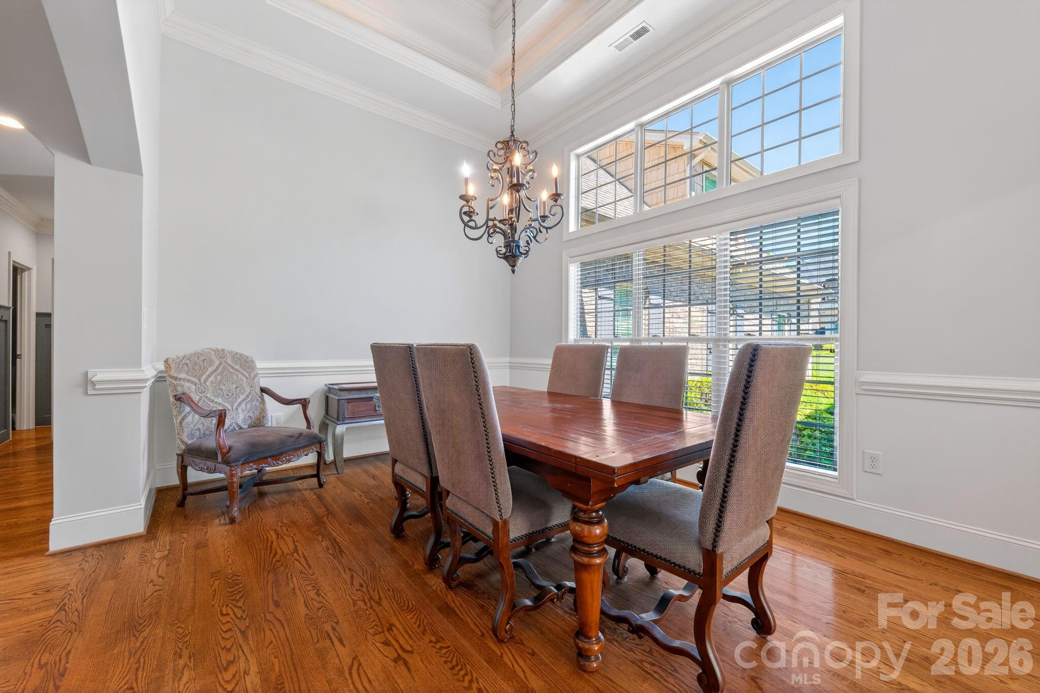 3138 Rappahannock Court, Unit 16 Matthews, NC 28104 - Photo 4 of 38 a view of a dining room with furniture a chandelier and wooden floor