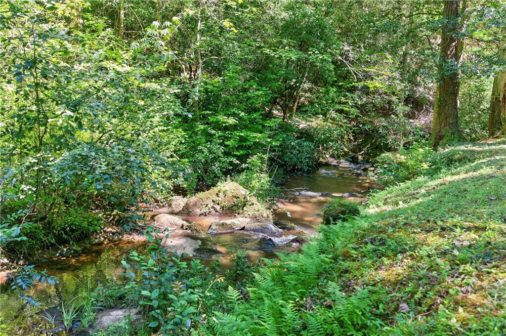 200 Bahn Innsbruck Helen, GA 30545 - Photo 21 of 27 a backyard of a house with lots of green space and a lake view