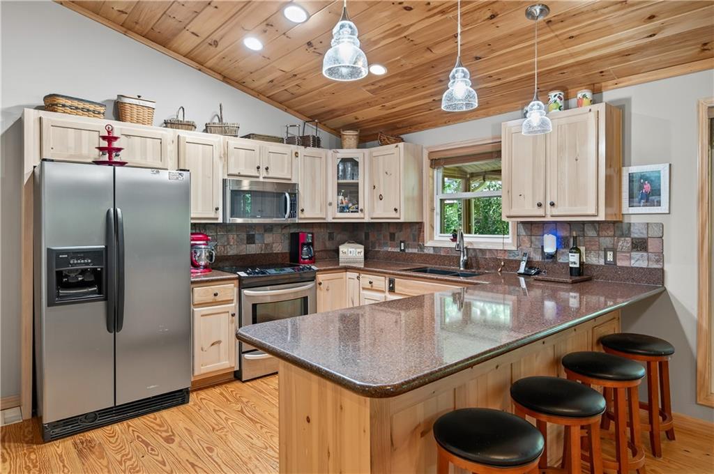 200 Bahn Innsbruck Helen, GA 30545 - Photo 6 of 27 a kitchen with stainless steel appliances granite countertop a sink a stove and a refrigerator