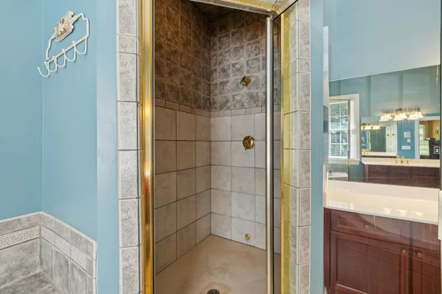 a bedroom with a large bed and a potted plant