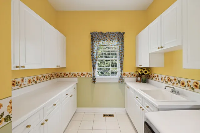 a living room with furniture and floor to ceiling windows