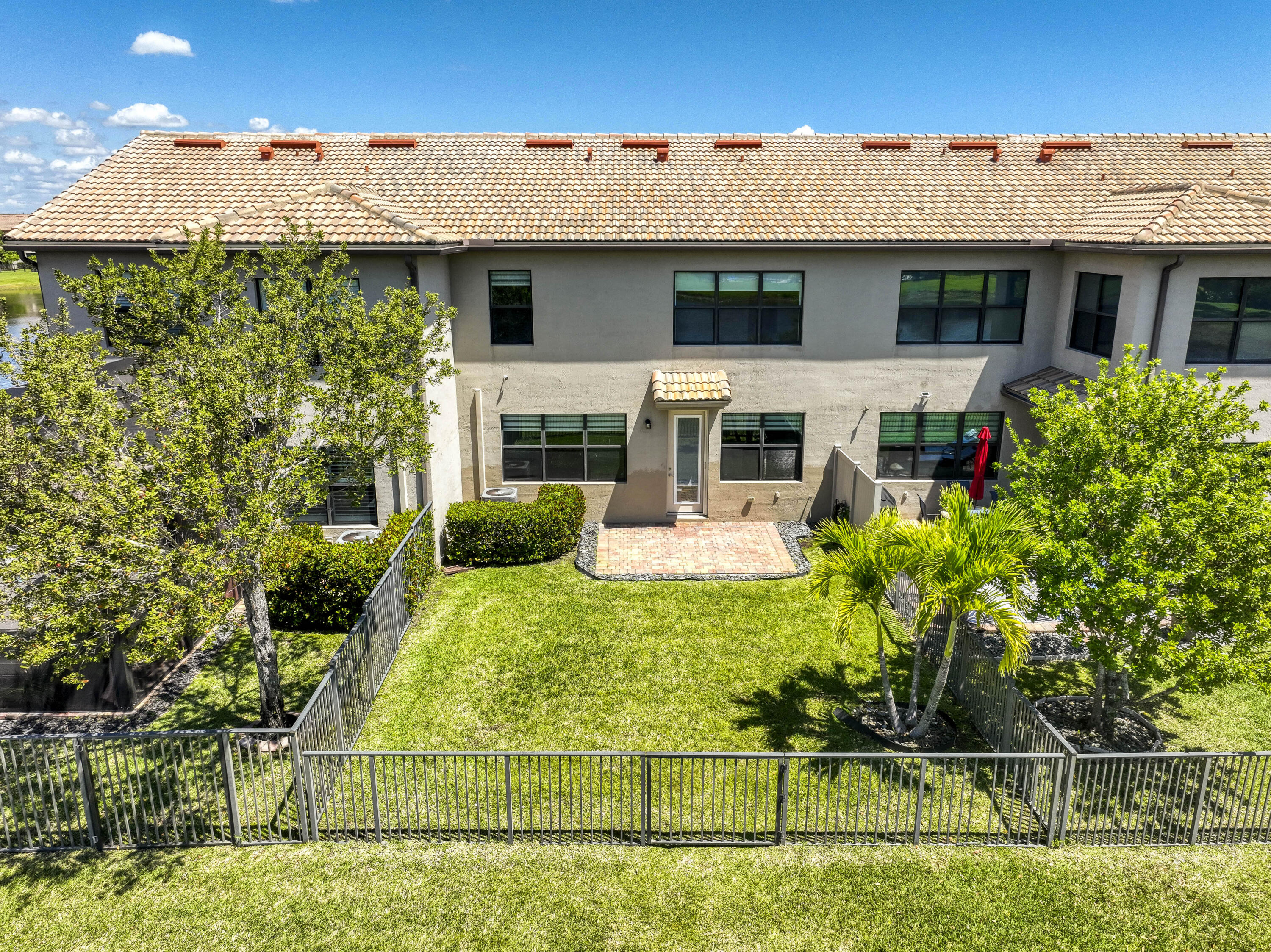 8301 Rearing Lane Lake Worth, FL 33467 - Photo 32 of 33 a view of a white house with large windows and plants