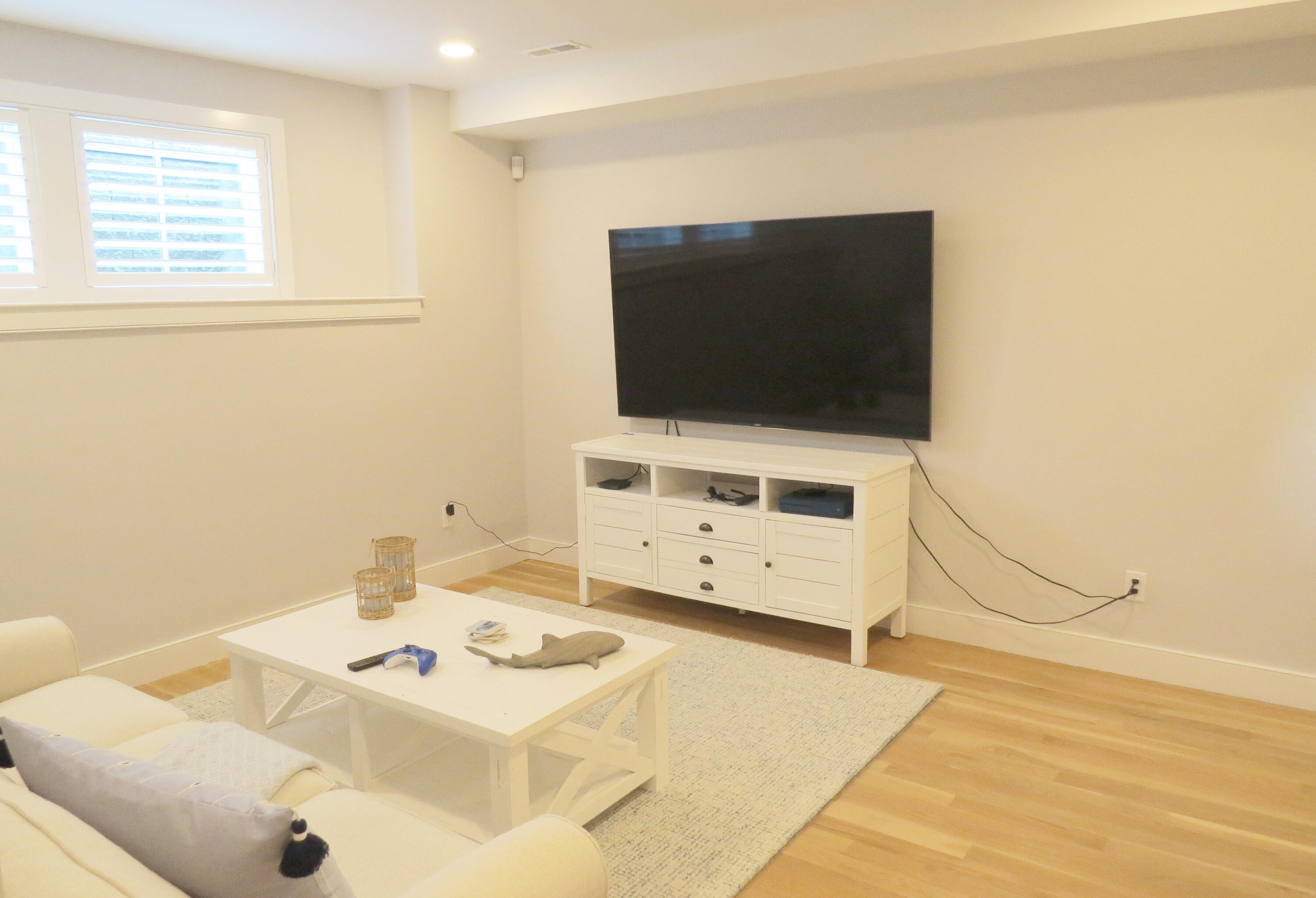 96 Hunter Rise Chatham, MA 02633 - Photo 13 of 37 a living room with a flat screen tv a washer and dryer