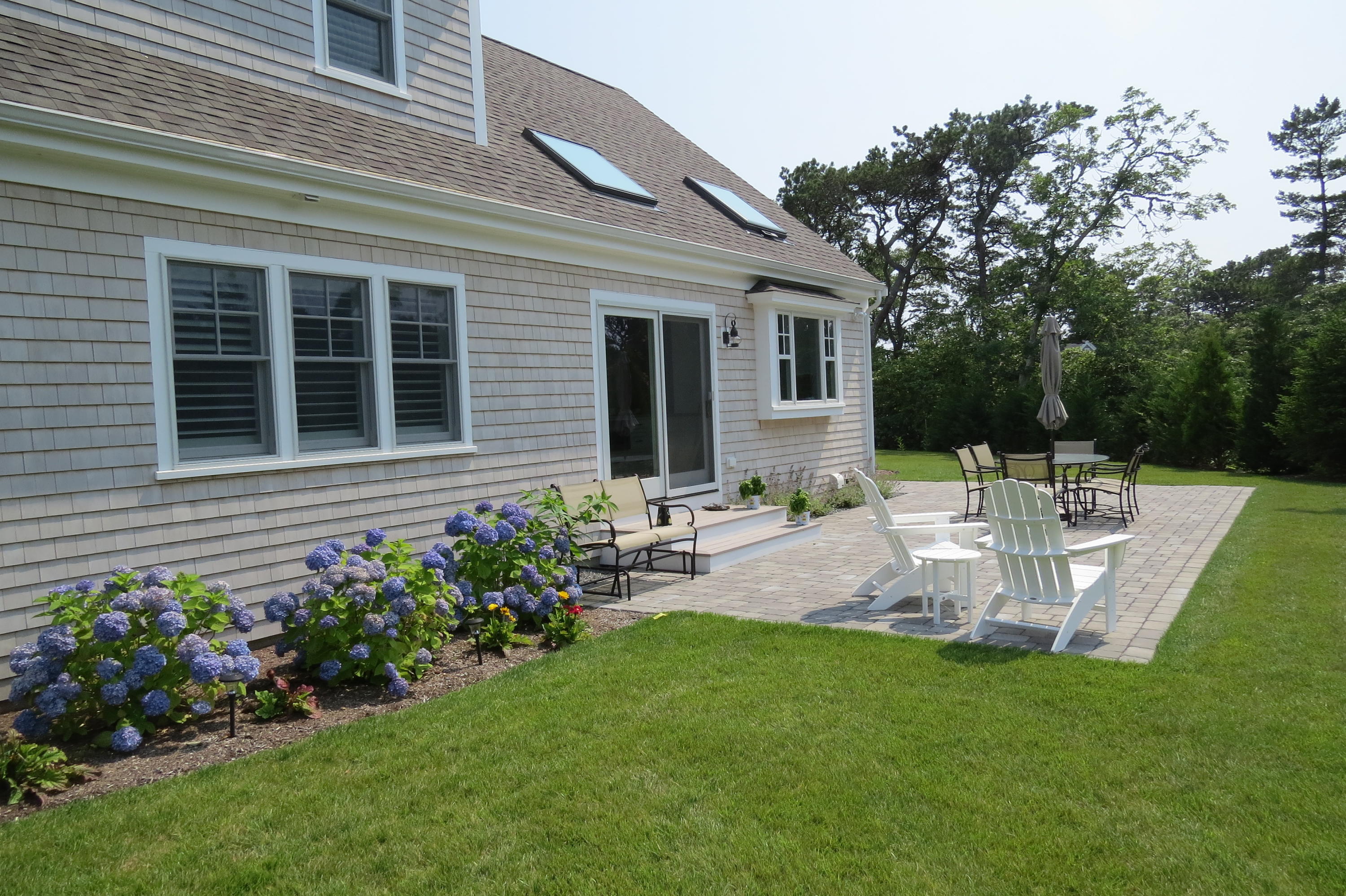 96 Hunter Rise Chatham, MA 02633 - Photo 20 of 37 a view of a chair and table in the garden