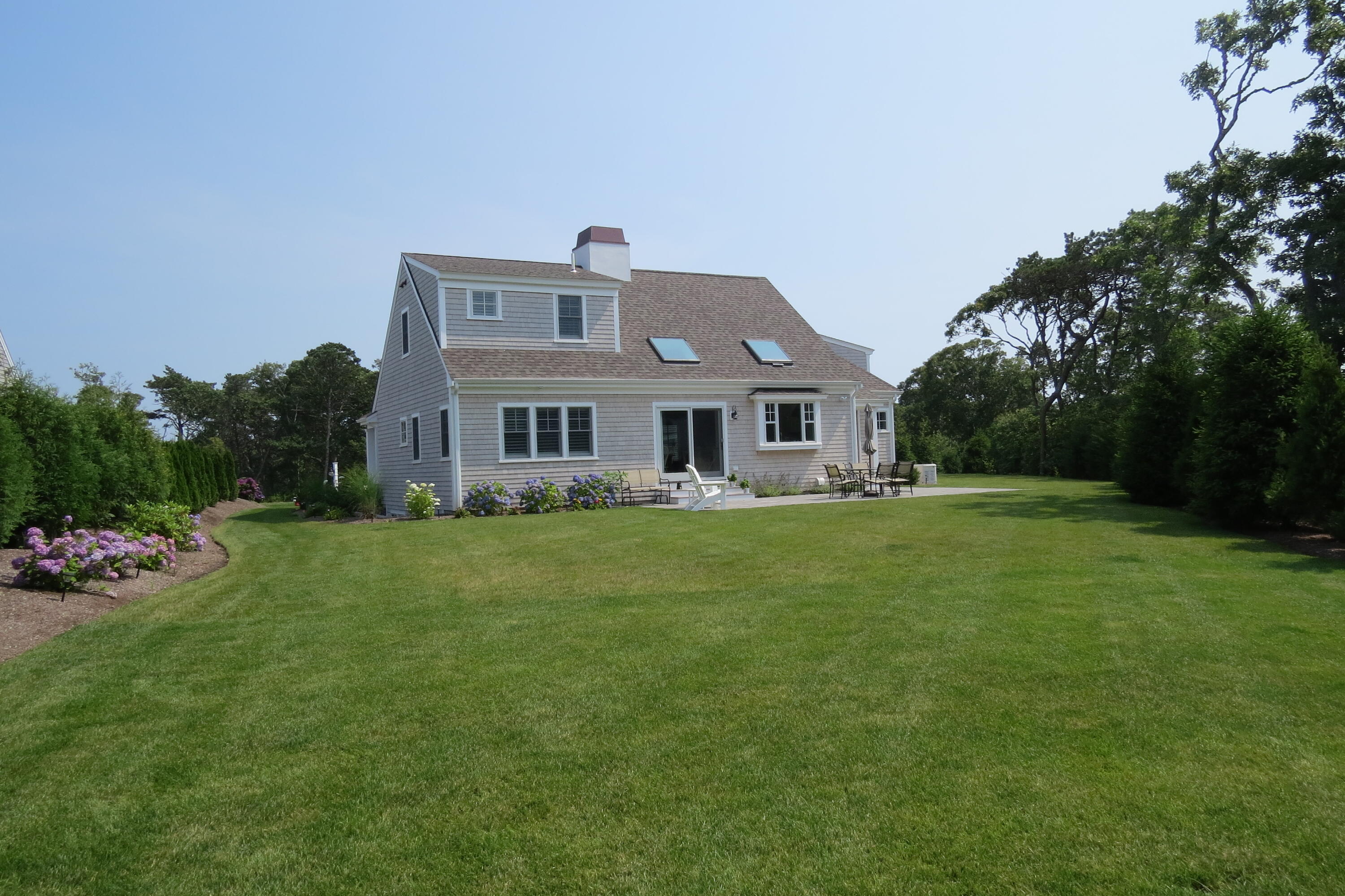 96 Hunter Rise Chatham, MA 02633 - Photo 22 of 37 a front view of a house with a garden and porch
