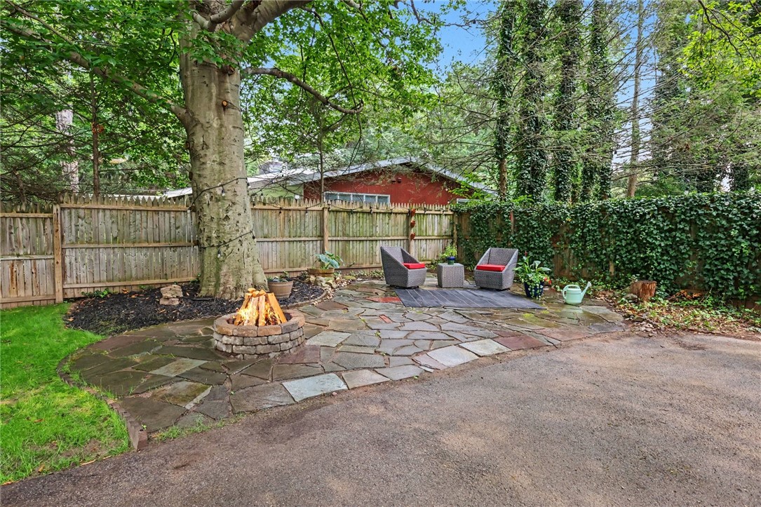374 Ashbourne Road Brighton, NY 14618 - Photo 29 of 33 Stone patio with fire pit is in the enclosed back yard and is the perfect place to entertain or unwind from the day.