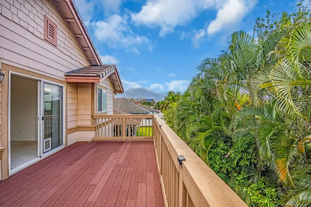 a view of balcony with wooden floor and fence