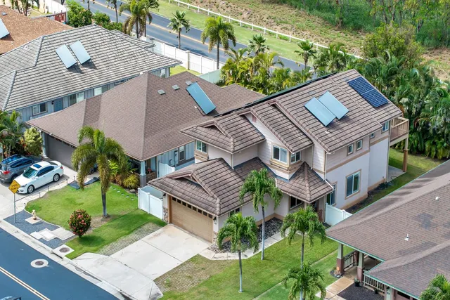 an aerial view of a house with garden space and street view