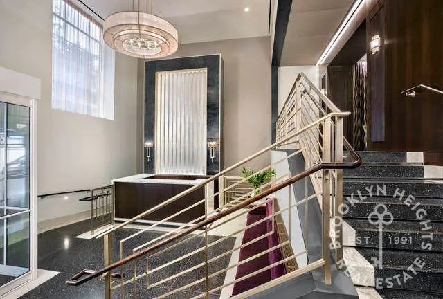 a front view of a building with large trees