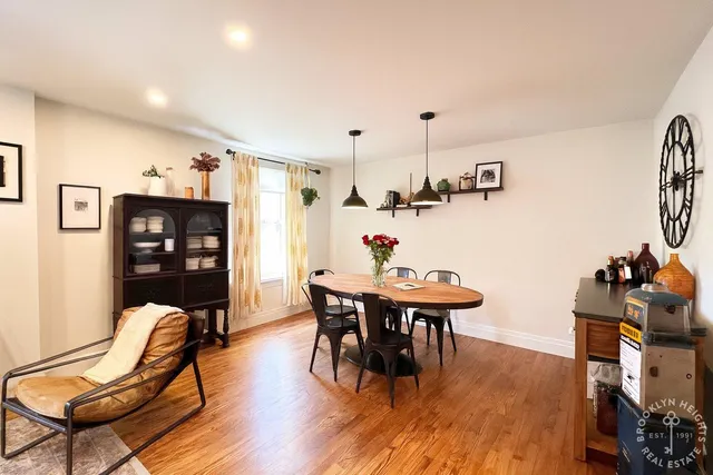 a living room with furniture wooden floor and a flat screen tv