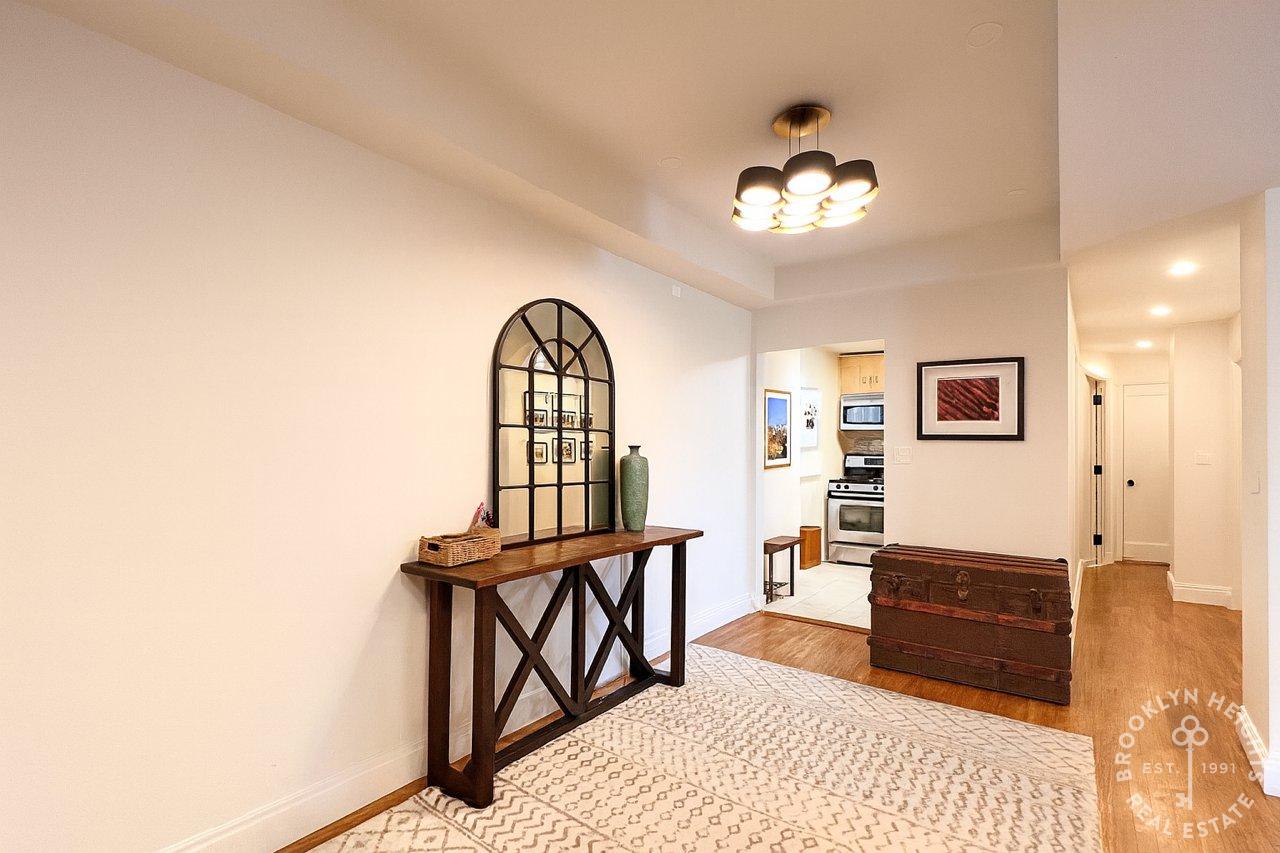 111 Hicks Street, Unit 5BC Brooklyn, NY 11201 - Photo 3 of 18 a living room with furniture a window and a chandelier