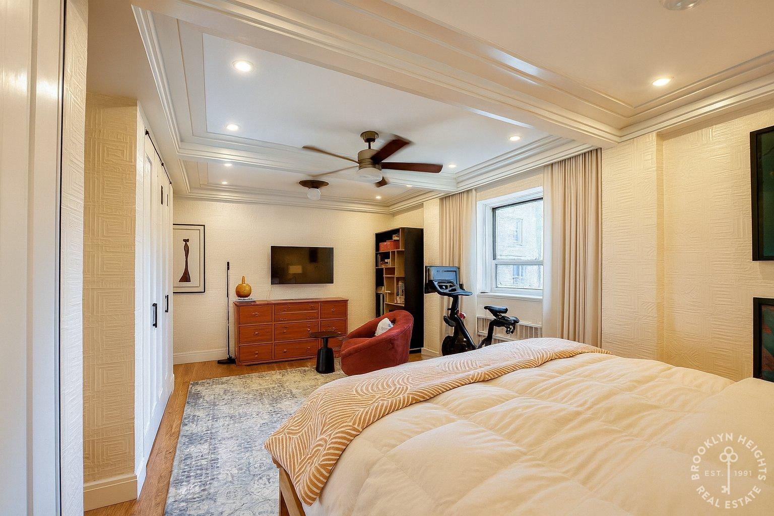 111 Hicks Street, Unit 5BC Brooklyn, NY 11201 - Photo 6 of 18 a bedroom with a bed and a large mirror with a flat tv screen