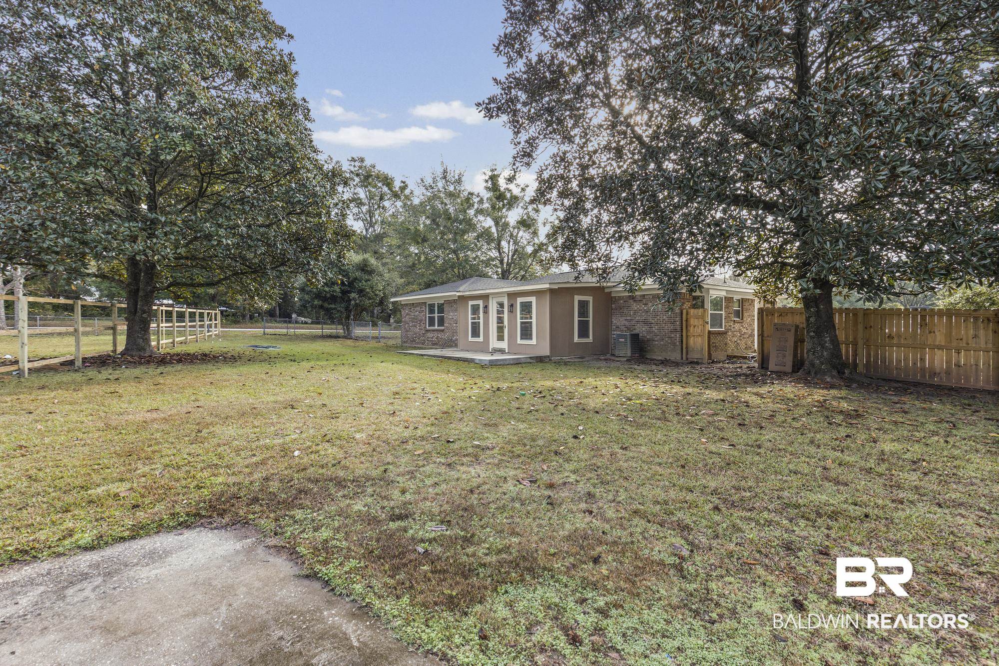 3041 Pretty Branch Drive East Mobile, AL 36618 - Photo 18 of 20 Back of property with a patio area, a fenced backyard, and view of scattered trees