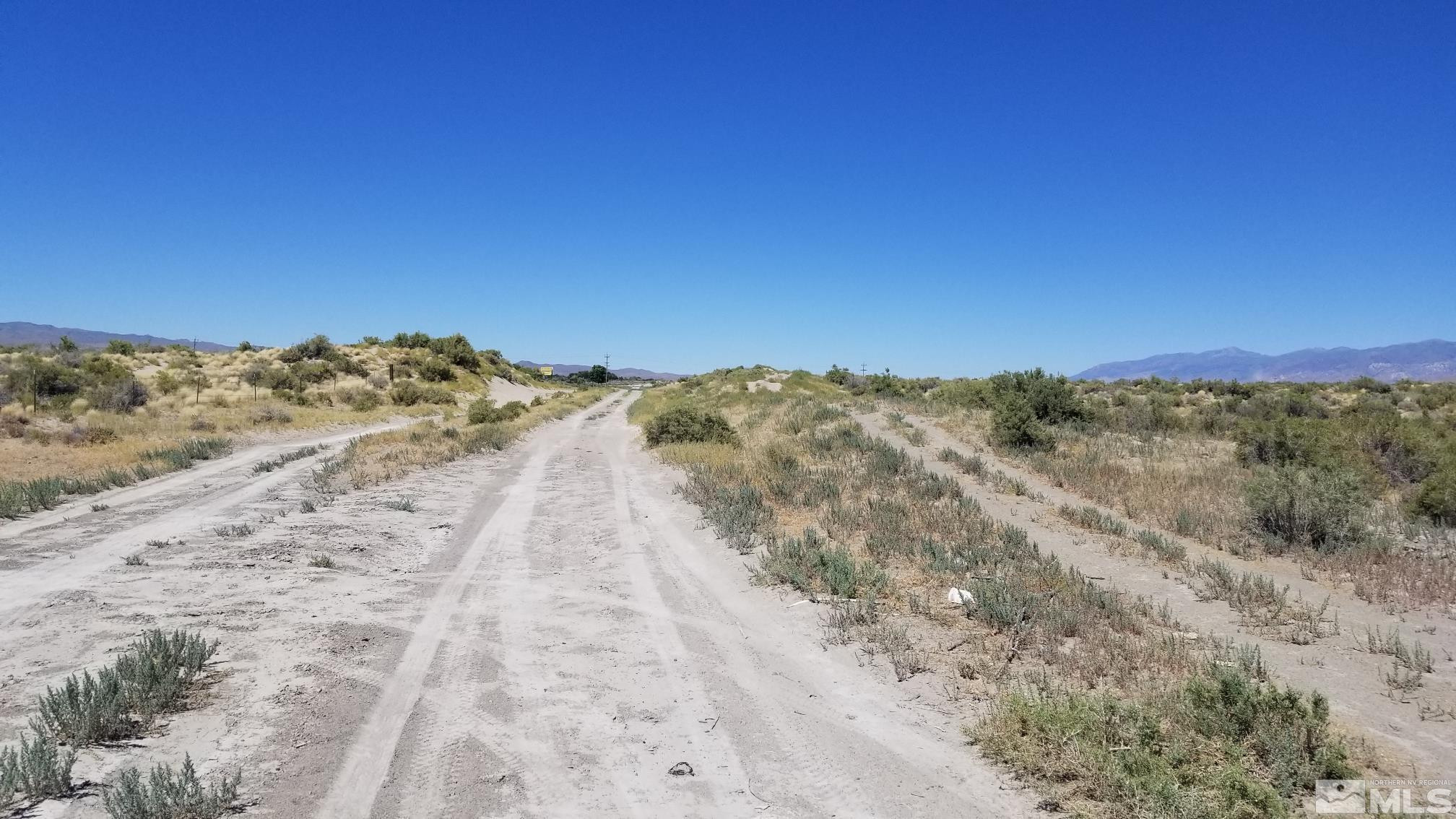 0 Airport Road Lovelock, NV 89419 - Photo 8 of 10 a view of a dry yard with mountains in the background