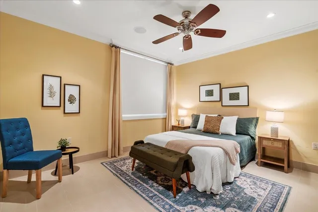 a bedroom with a bed a couch and a chandelier