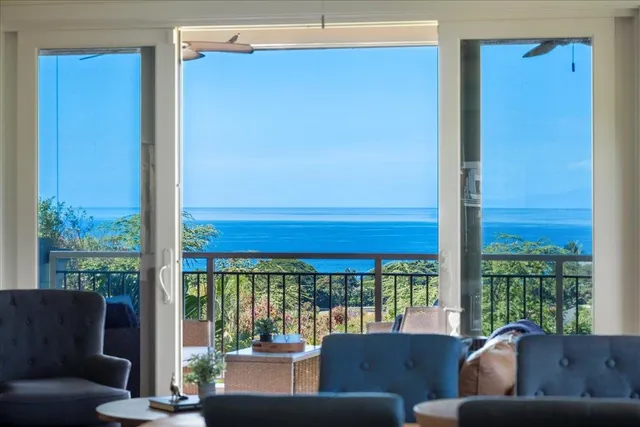 a living room with furniture and a floor to ceiling window