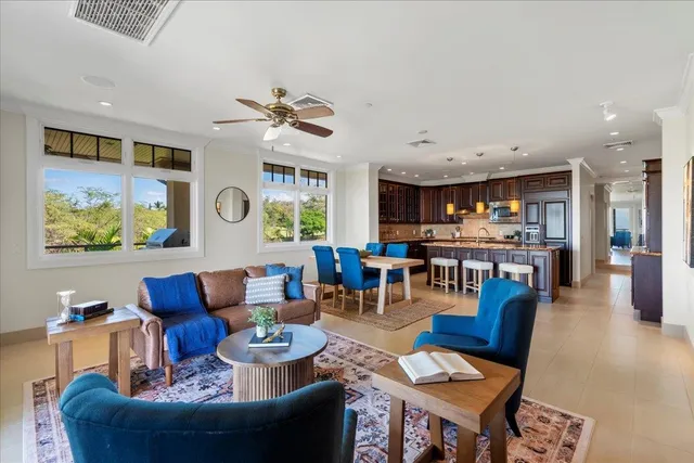 a living room with furniture kitchen view and a table
