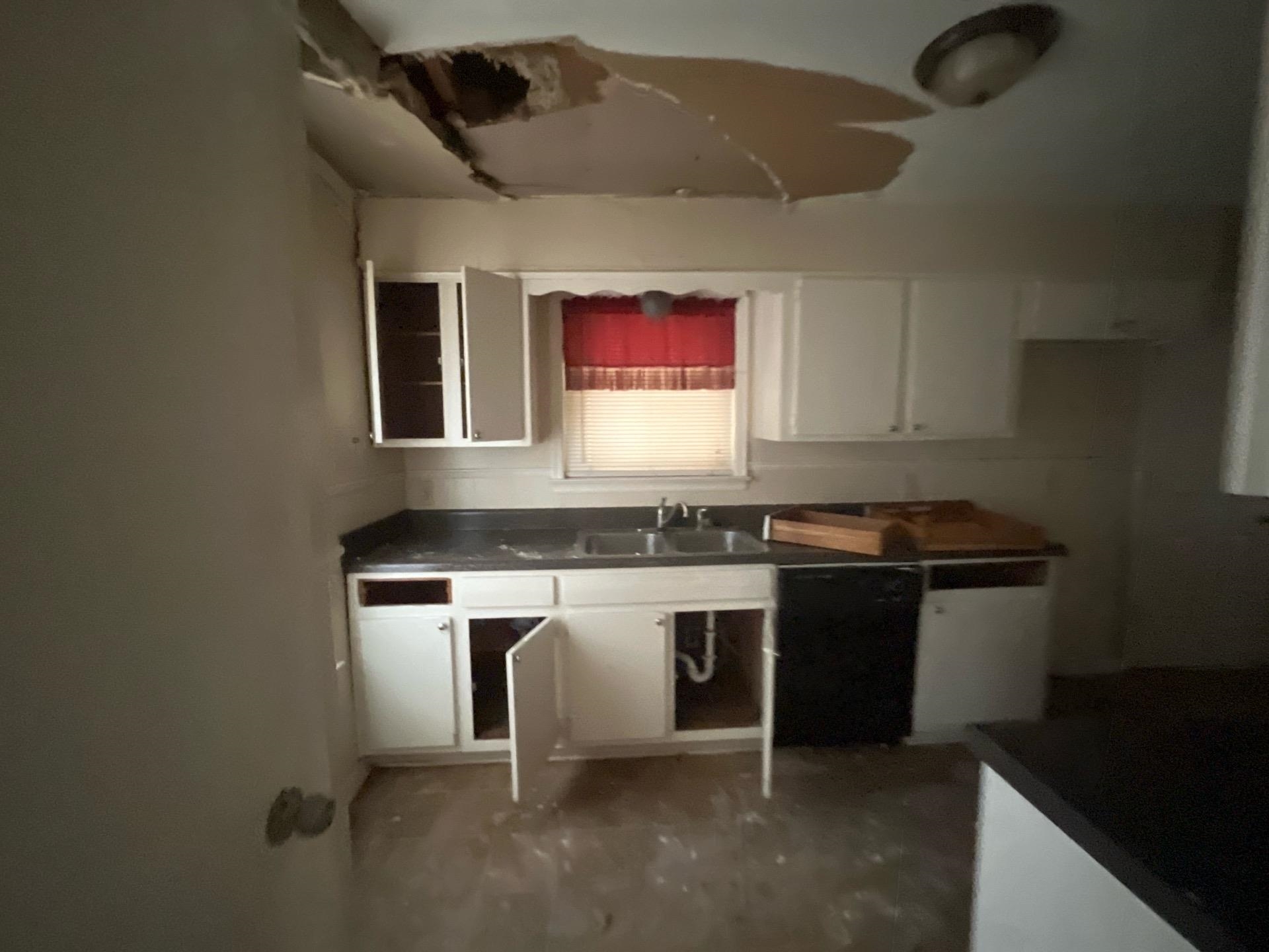 4706 Stage Road Memphis, TN 38128 - Photo 2 of 6 Kitchen featuring dark countertops, white cabinetry, and dishwasher