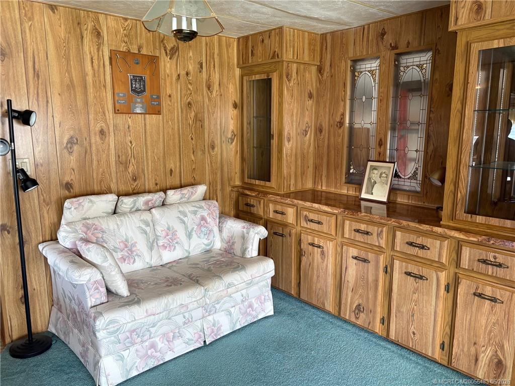 2856 Southwest Toronado Trail Stuart, FL 34997 - Photo 8 of 20 a living room with furniture and large mirror