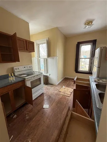 a kitchen with kitchen island a stove and a refrigerator