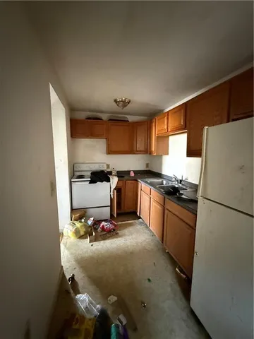 a kitchen with granite countertop a refrigerator stove and microwave