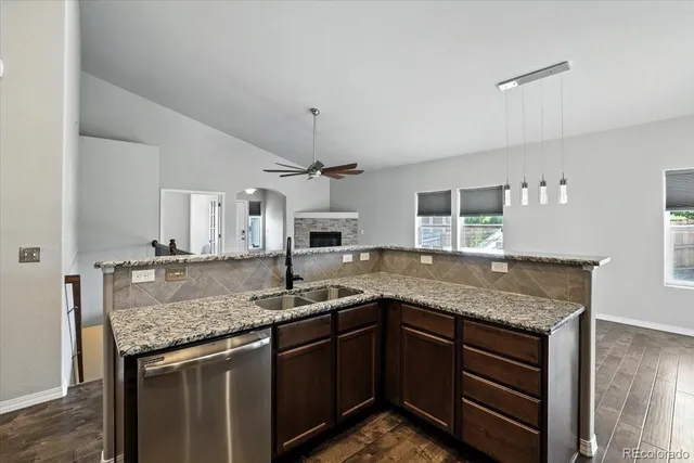 a kitchen with stainless steel appliances granite countertop a sink stove and cabinets