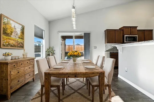 a dining room with furniture and window