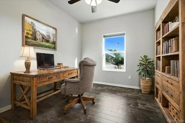 a view of a workspace with furniture and a window